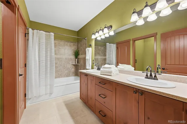 a spacious bathroom with a double vanity sink mirror and shower
