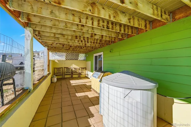 a view of a patio with a table and chairs