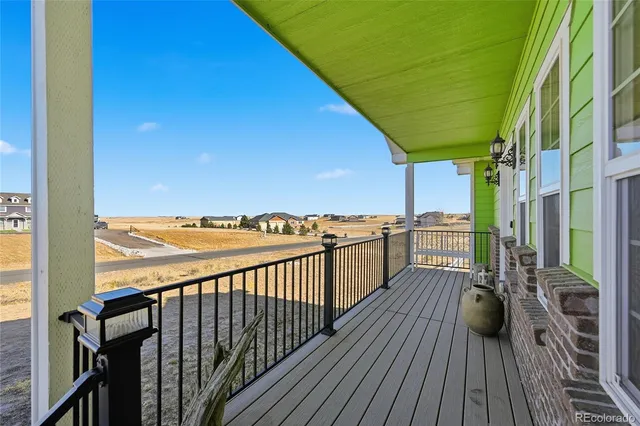a view of a balcony with wooden floor