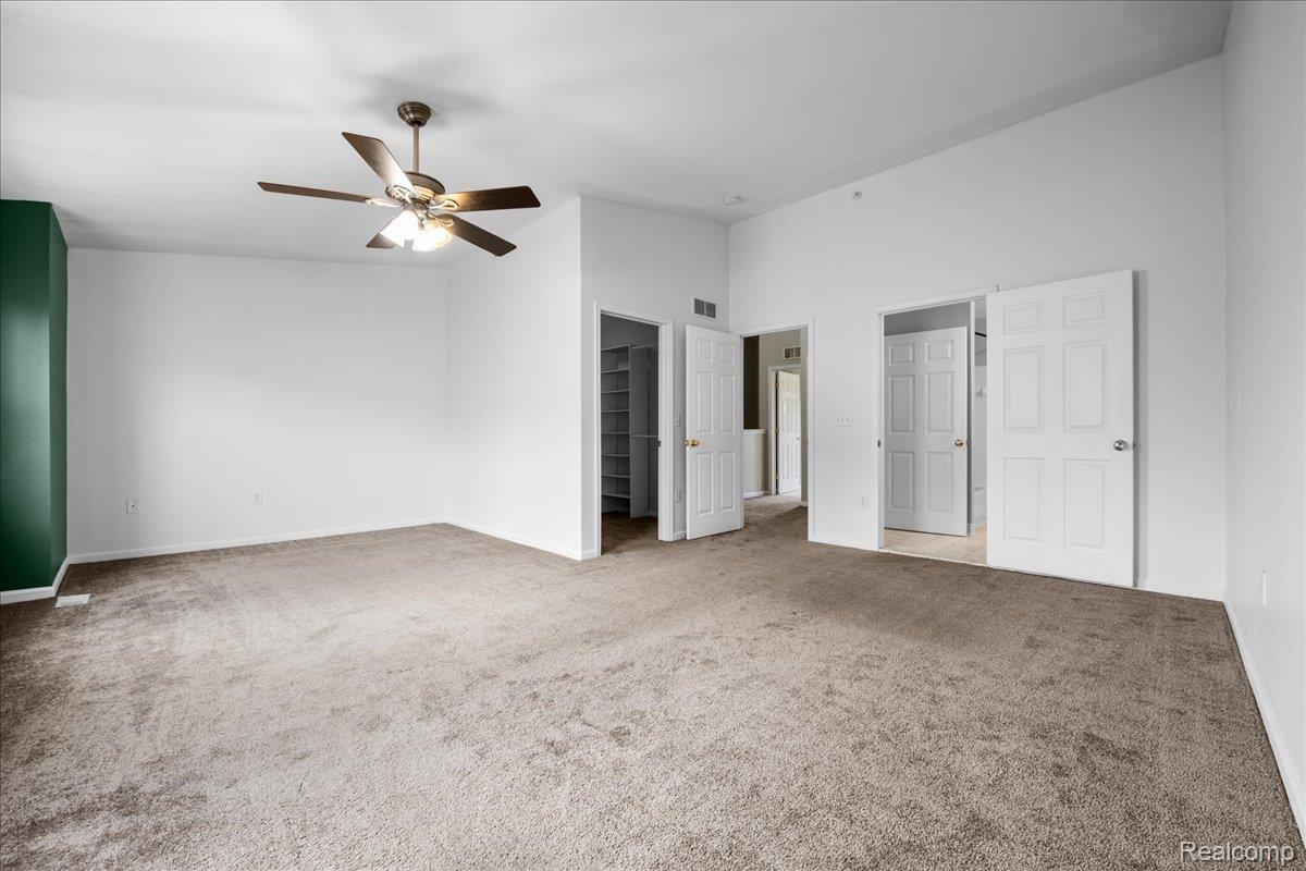 22684 Goddard Road Taylor, MI 48180 - Photo 22 of 29 Spacious room featuring vaulted ceilings, carpeted flooring, a ceiling fan with integrated lighting, and multiple interior doorways