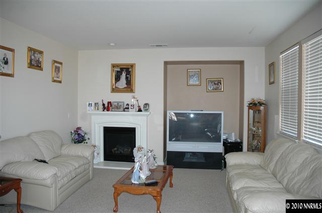 2407 Spring Flower Drive Reno, NV 89521 - Photo 4 of 4 a living room with furniture and a fireplace