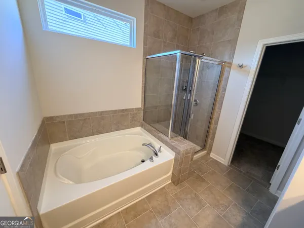 a bathroom with bathtub and a shower