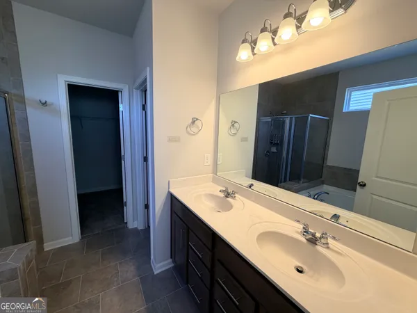 a bathroom with a double vanity sink and a mirror