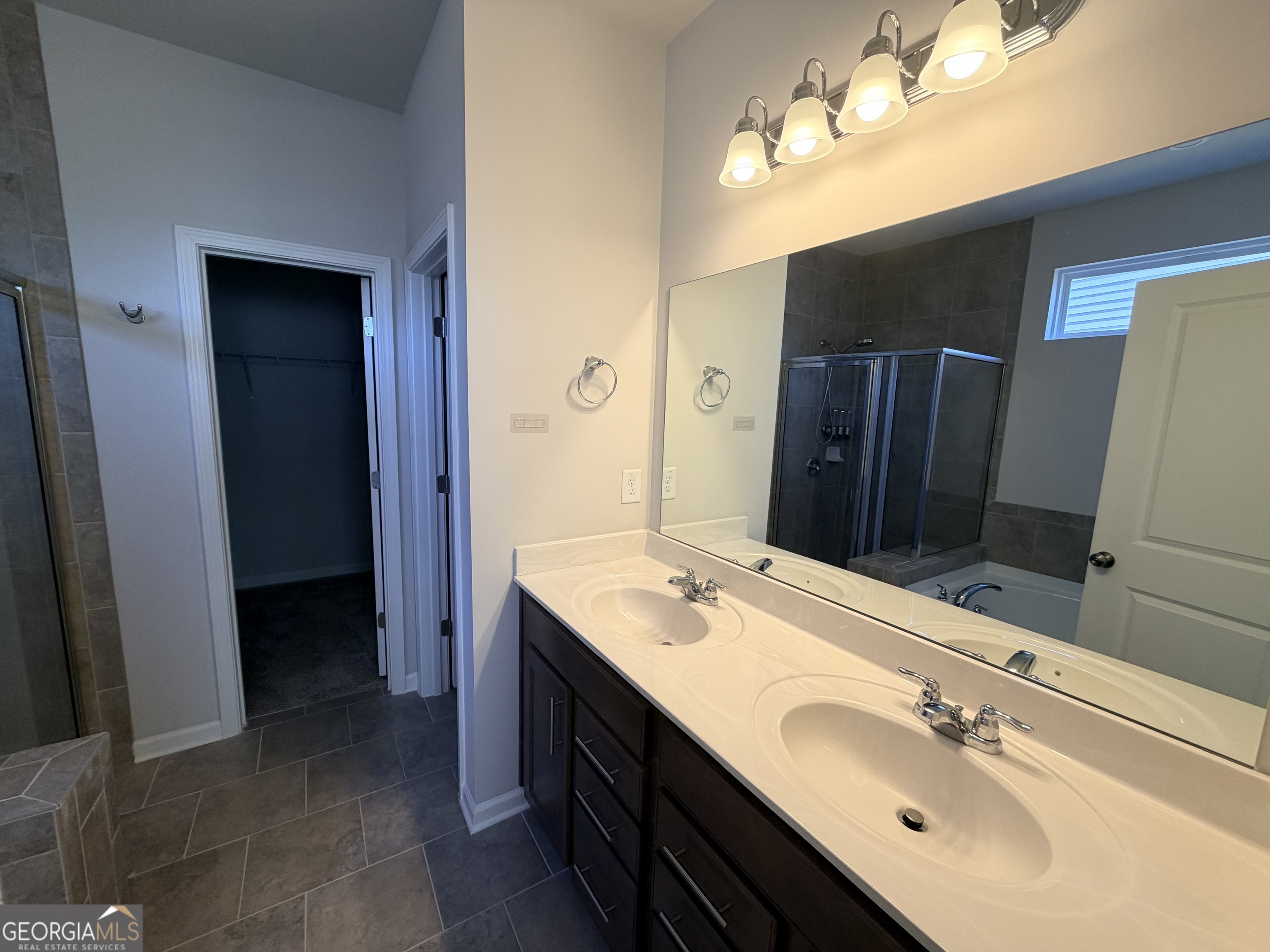 3283 Lowell Road Bethlehem, GA 30620 - Photo 14 of 31 a bathroom with a double vanity sink and a mirror