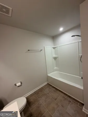 a view of a livingroom with a ceiling fan and window