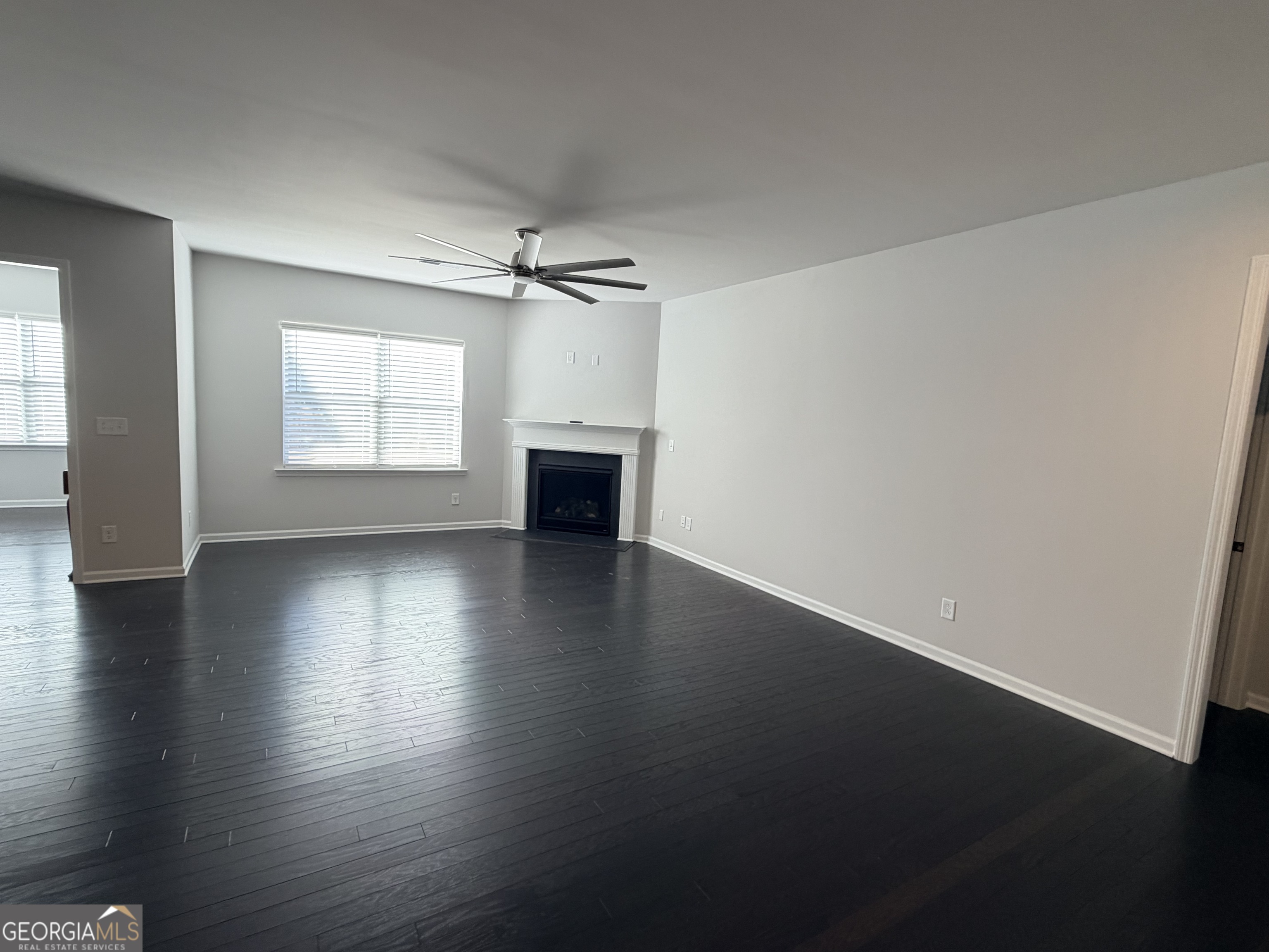 3283 Lowell Road Bethlehem, GA 30620 - Photo 4 of 31 an empty room with wooden floor and windows