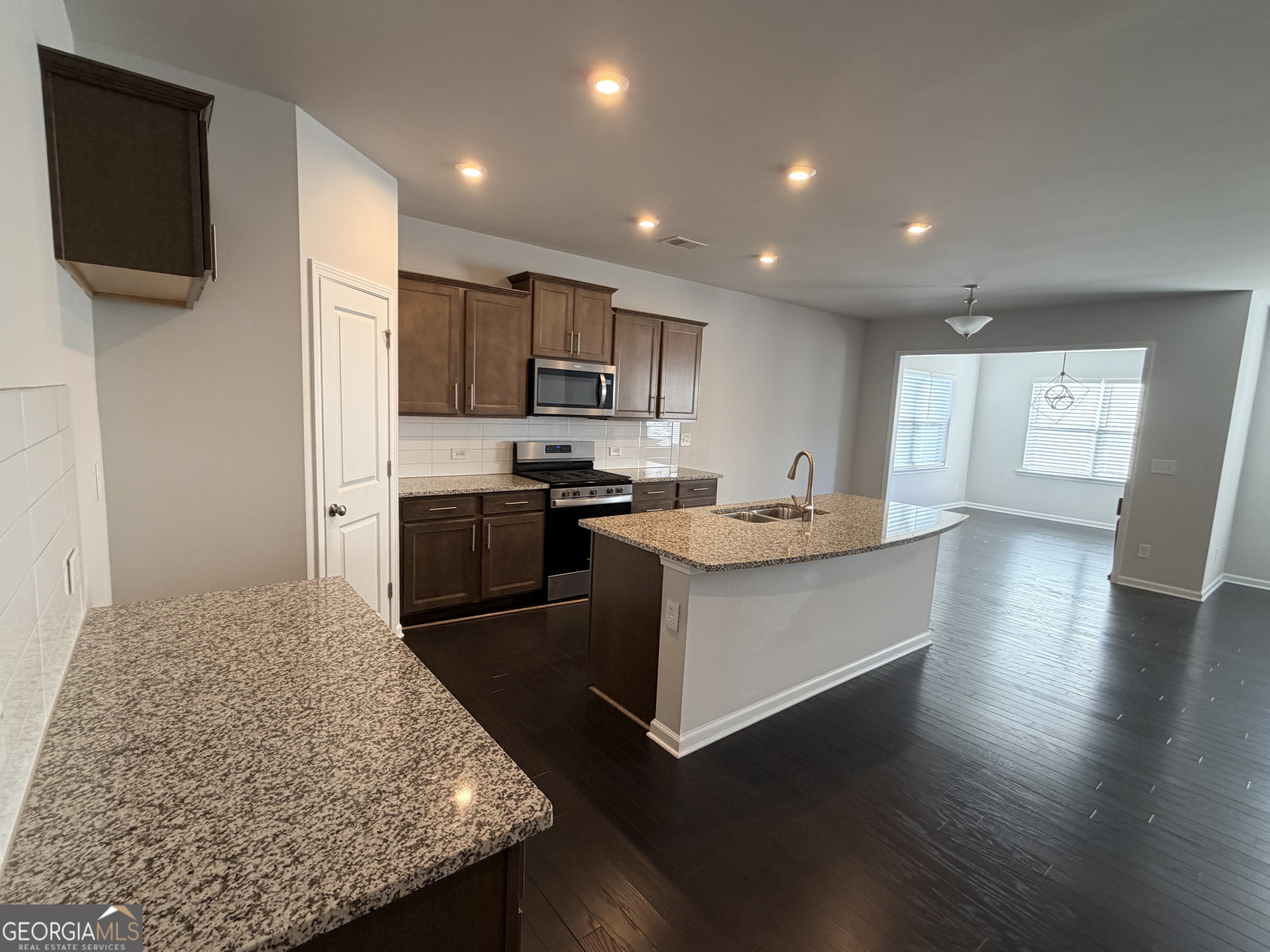 3283 Lowell Road Bethlehem, GA 30620 - Photo 5 of 31 a kitchen with kitchen island sink stove and refrigerator
