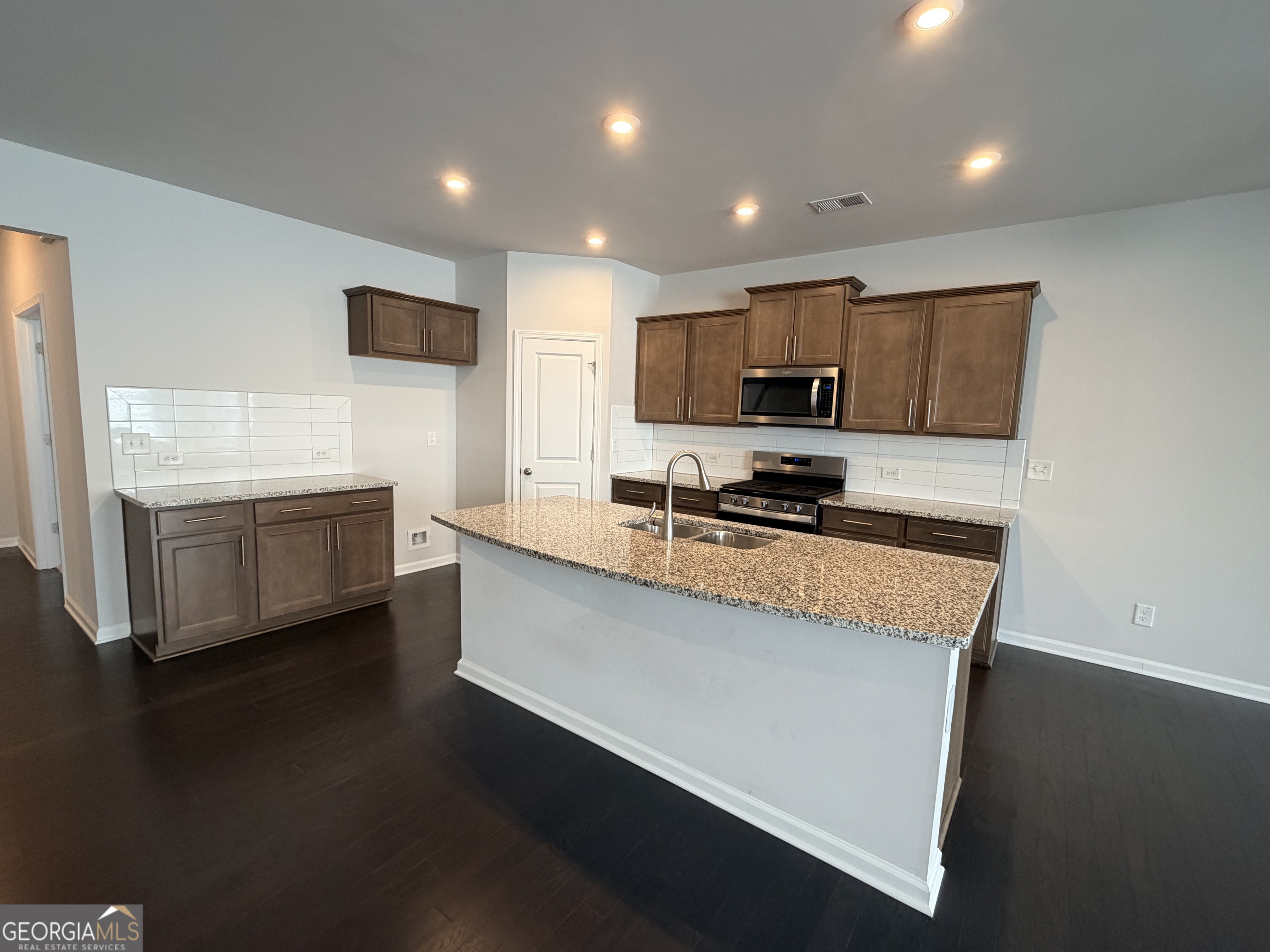 3283 Lowell Road Bethlehem, GA 30620 - Photo 7 of 31 a kitchen with stainless steel appliances granite countertop a stove a sink and a microwave