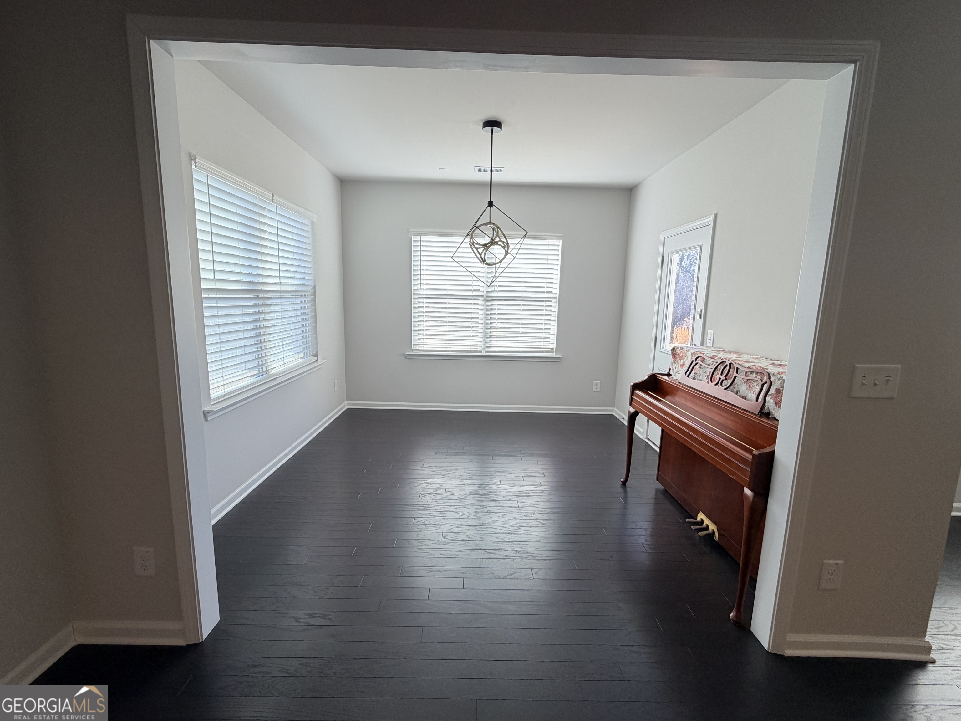 3283 Lowell Road Bethlehem, GA 30620 - Photo 8 of 31 an empty room with windows and wooden floor