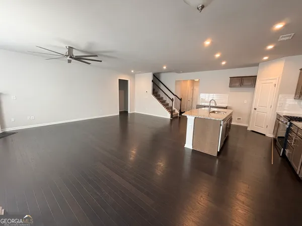 an entryway in a hall with a kitchen