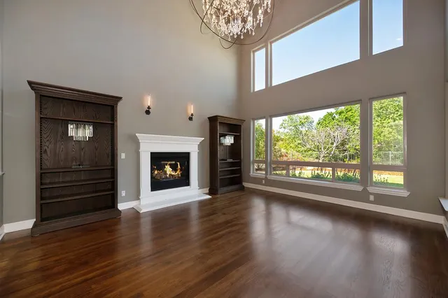a spacious bathroom with a granite countertop sink a large mirror and a window