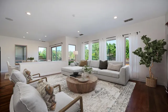 a bathroom with a granite countertop sink and a bathtub