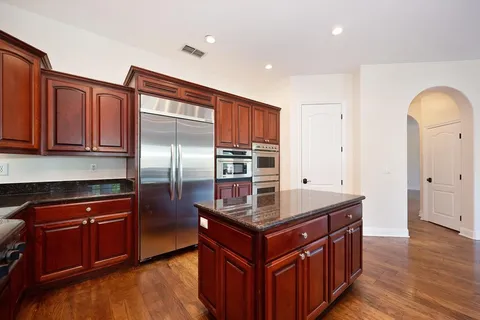 a front view of a house with a garden