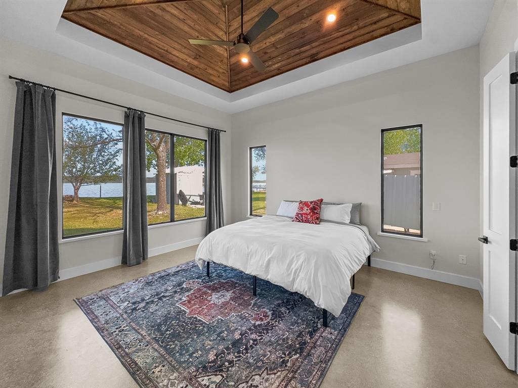 1163 Willow Road Graford, TX 76449 - Photo 12 of 31 a bed sitting in a spacious bedroom next to a window