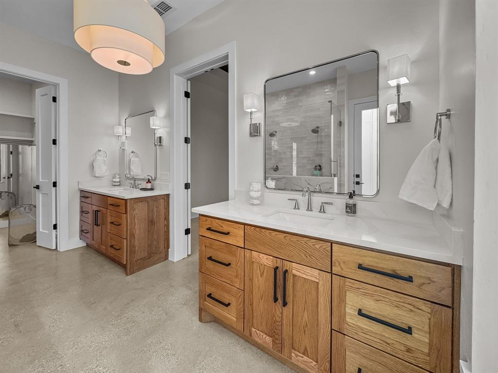 1163 Willow Road Graford, TX 76449 - Photo 15 of 31 a spacious bathroom with a double vanity sink a mirror and a shower