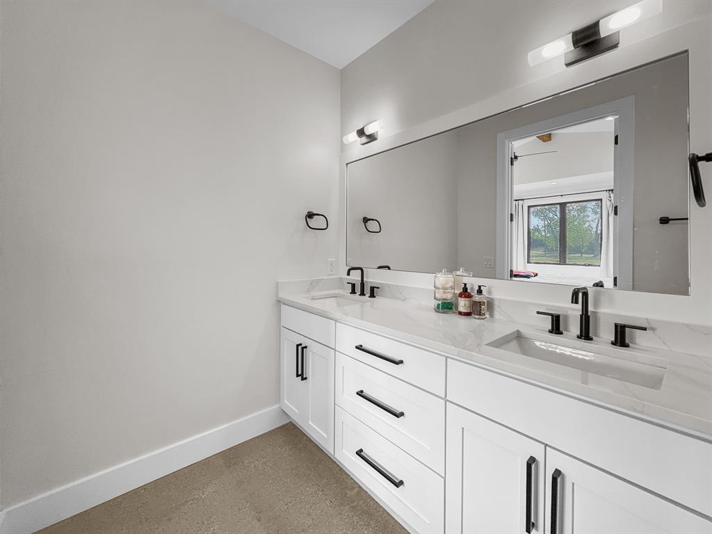 1163 Willow Road Graford, TX 76449 - Photo 22 of 31 a bathroom with double sink and a mirror