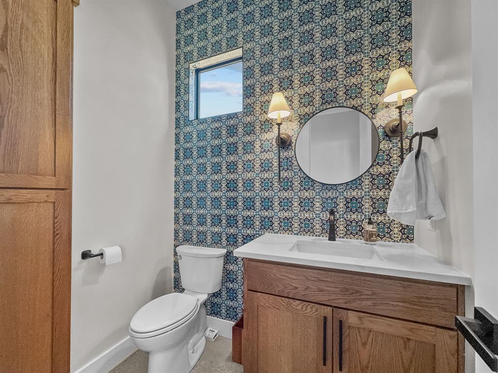 1163 Willow Road Graford, TX 76449 - Photo 28 of 31 a bathroom with a toilet sink and mirror