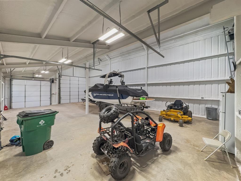 1163 Willow Road Graford, TX 76449 - Photo 29 of 31 a car and bike parked in a garage