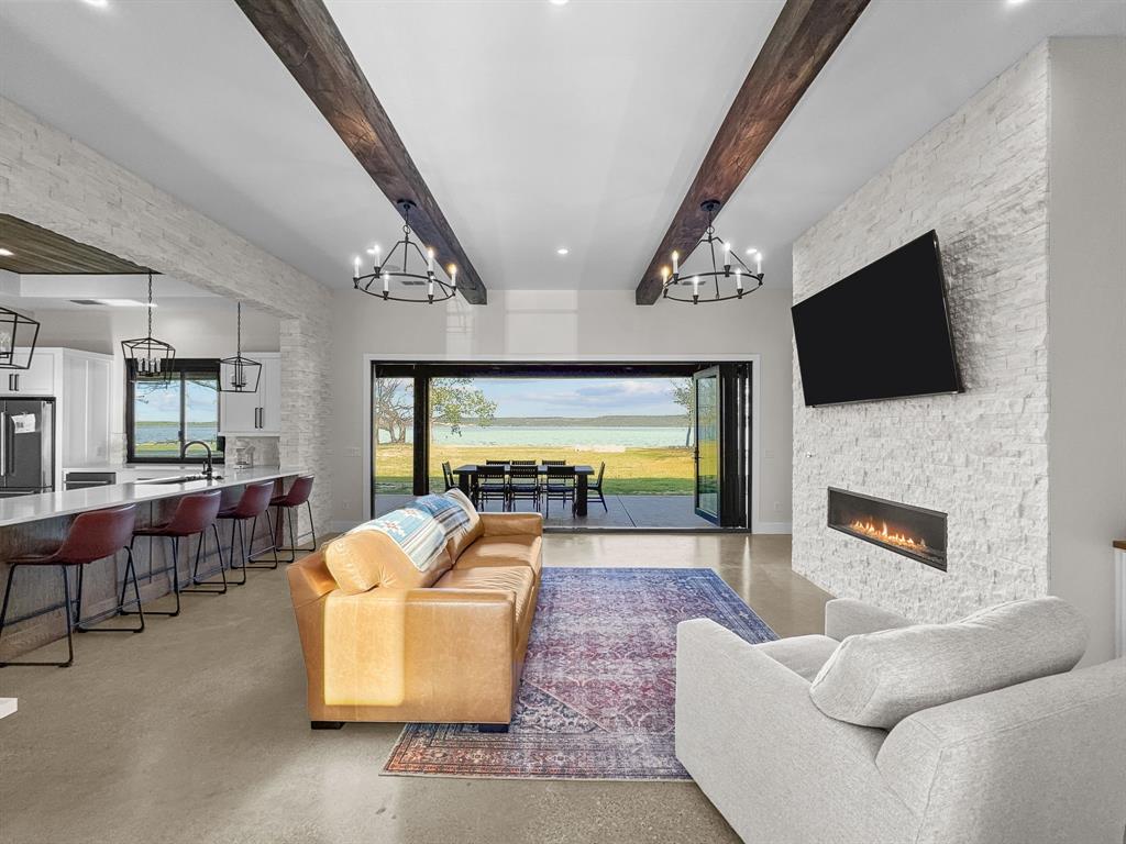 1163 Willow Road Graford, TX 76449 - Photo 3 of 31 a living room with fireplace furniture and a flat screen tv