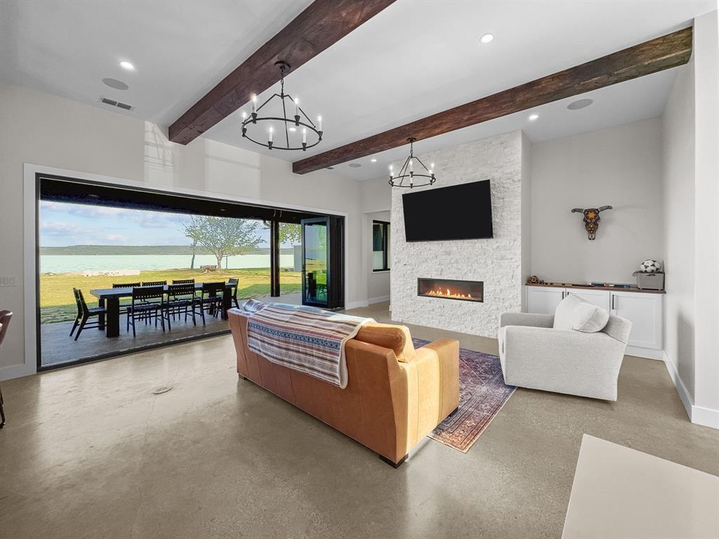 1163 Willow Road Graford, TX 76449 - Photo 4 of 31 a living room with fireplace furniture and a flat screen tv