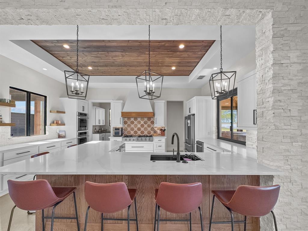 1163 Willow Road Graford, TX 76449 - Photo 6 of 31 a kitchen with a dining table chairs sink and granite counter top