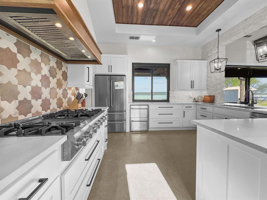 1163 Willow Road Graford, TX 76449 - Photo 7 of 31 a kitchen with stainless steel appliances granite countertop a stove and a sink