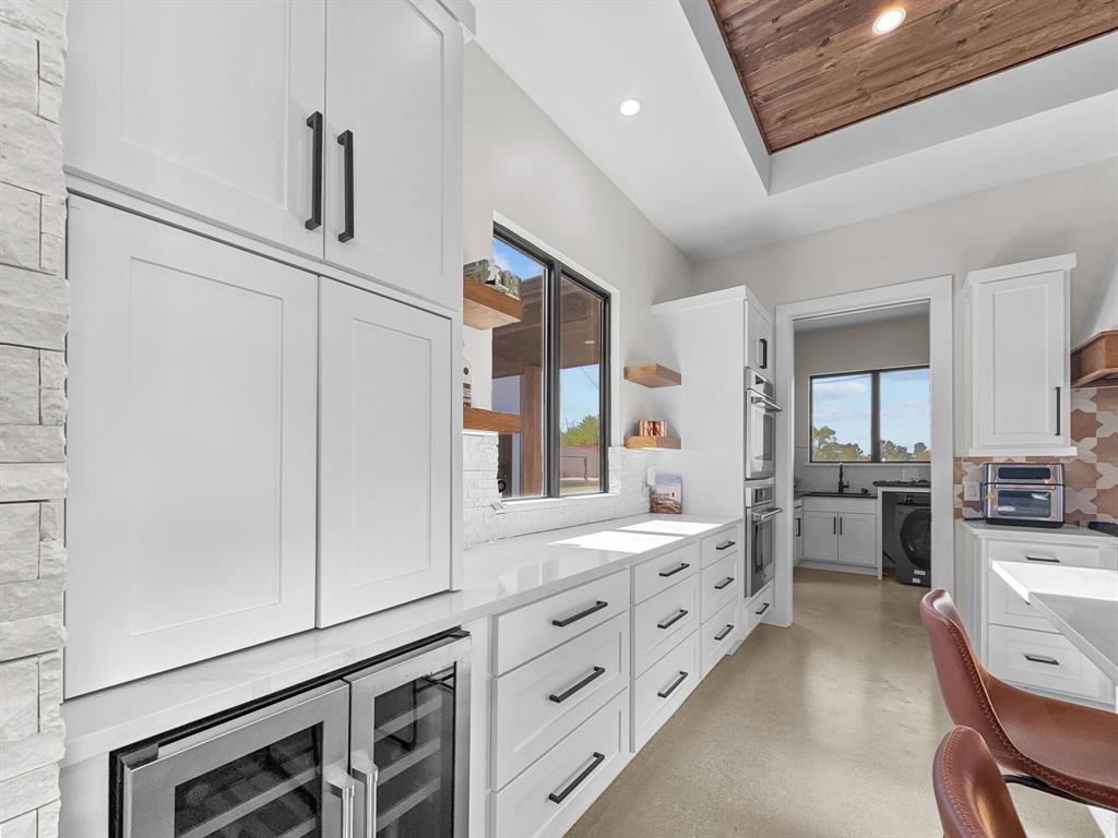 1163 Willow Road Graford, TX 76449 - Photo 10 of 31 a large white kitchen with cabinets