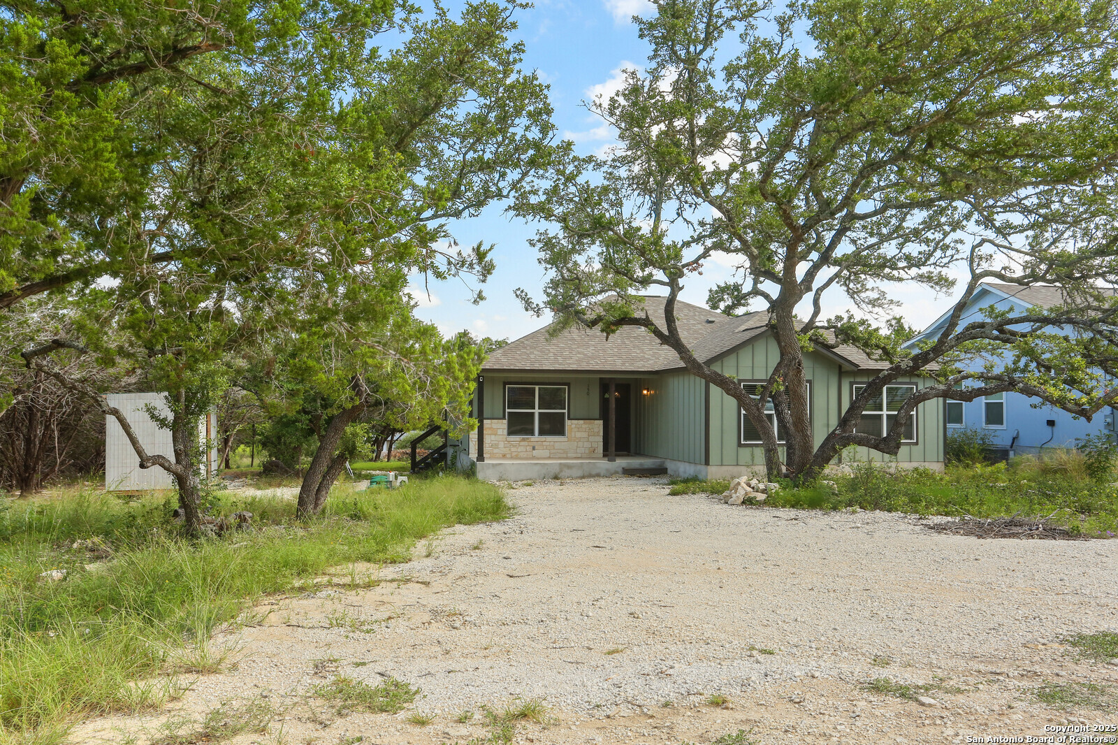 150 Hill Drive Spring Branch, TX 78070 - Photo 2 of 21 a front view of a house with a yard and trees
