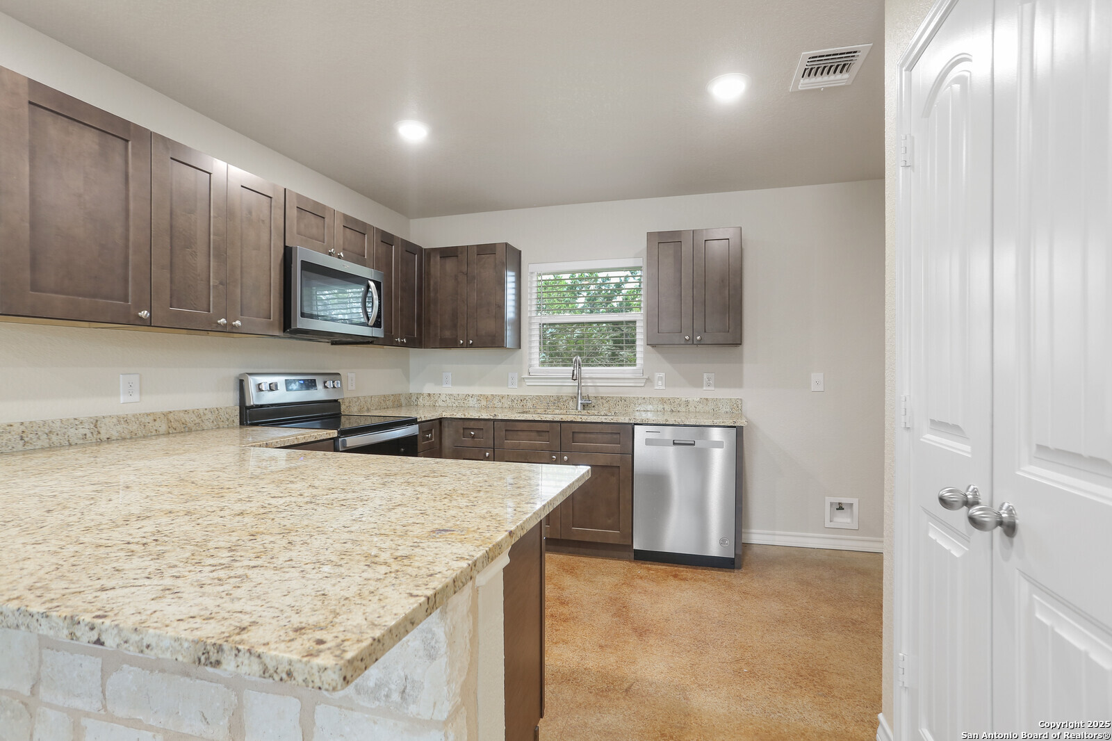 150 Hill Drive Spring Branch, TX 78070 - Photo 9 of 21 a kitchen with stainless steel appliances granite countertop a sink stove and refrigerator