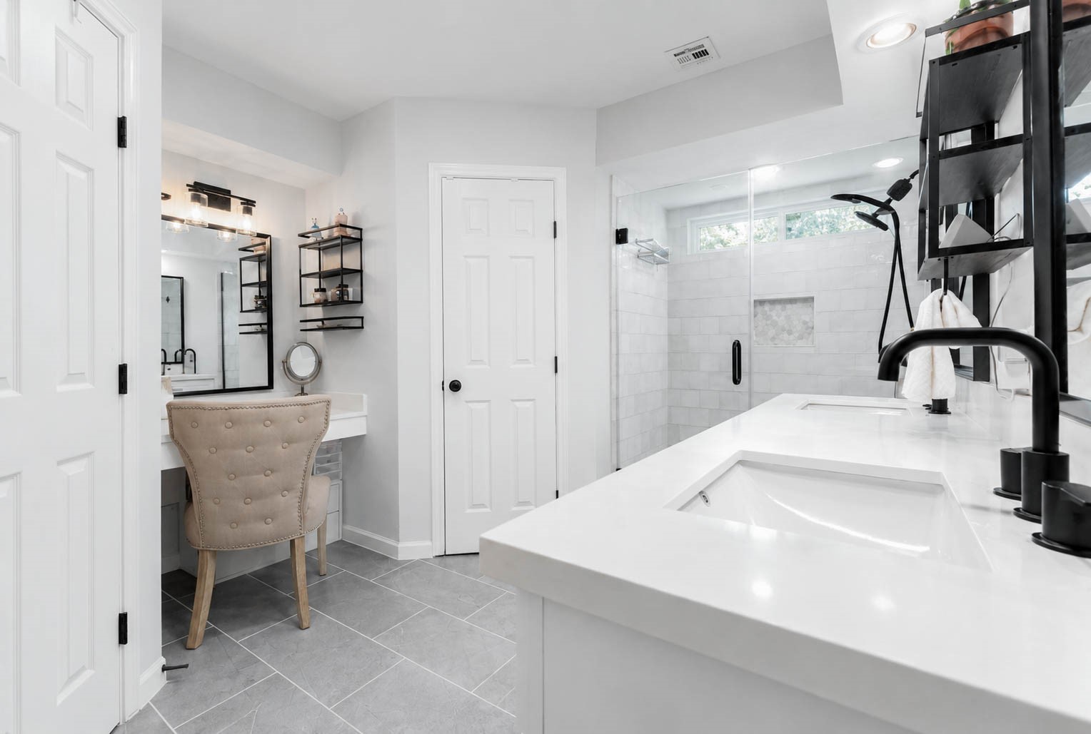 630 South Fry Road Katy, TX 77450 - Photo 26 of 48 Modern bathroom featuring a spacious glass-enclosed shower, dual sinks with sleek black fixtures, and ample storage in a bright, elegant design.
