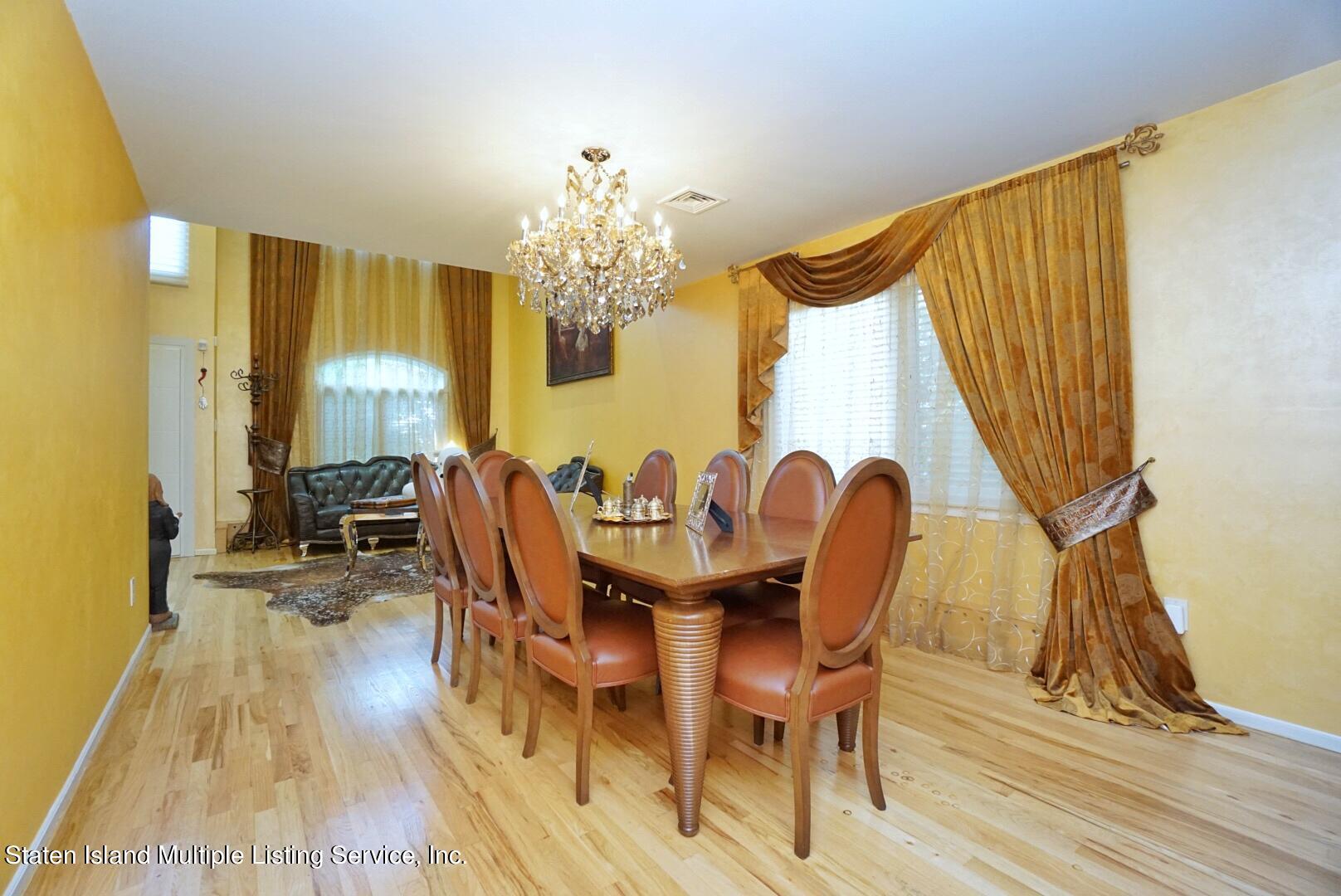 67 Covington Circle Staten Island, NY 10312 - Photo 11 of 45 a view of a dining room with furniture and chandelier