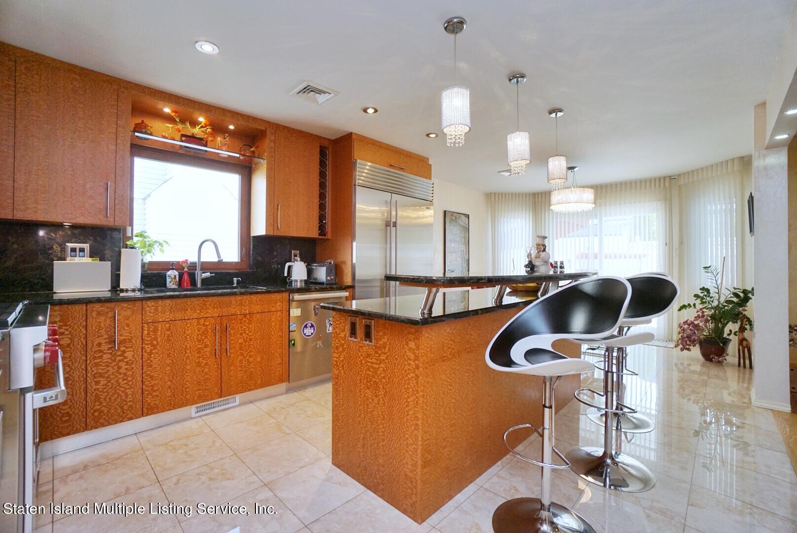 67 Covington Circle Staten Island, NY 10312 - Photo 14 of 45 a kitchen with stainless steel appliances a sink a counter top space cabinets and a window