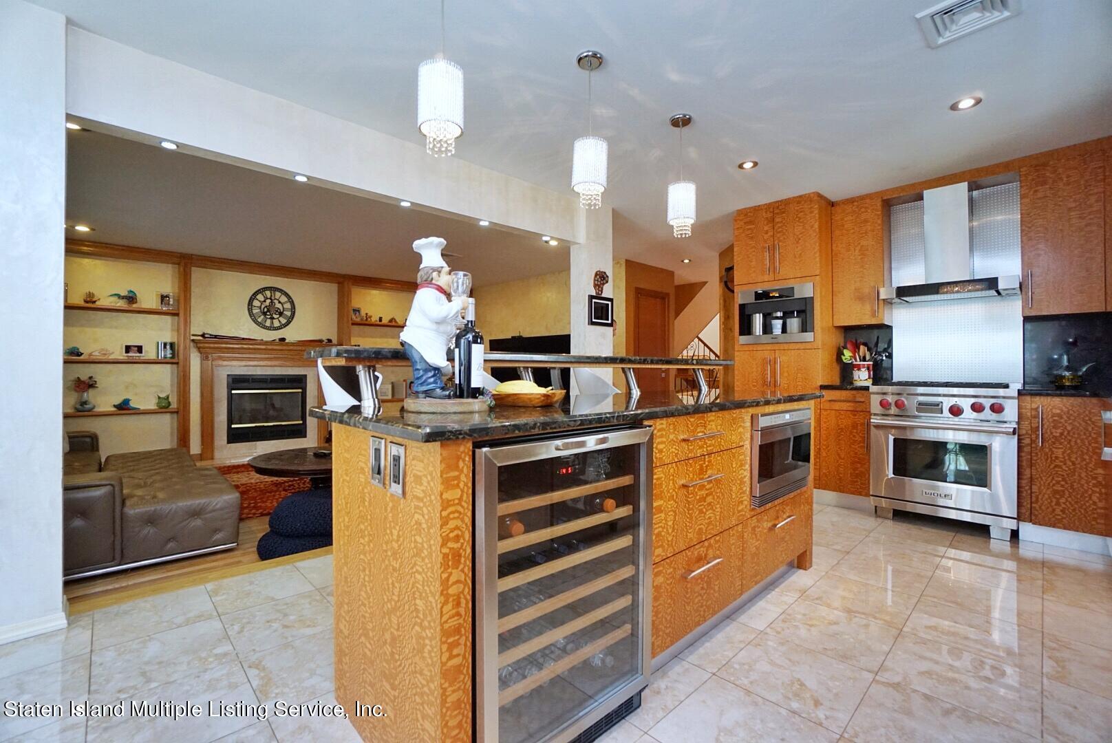 67 Covington Circle Staten Island, NY 10312 - Photo 17 of 45 a kitchen with stainless steel appliances kitchen island granite countertop a stove a sink and a refrigerator