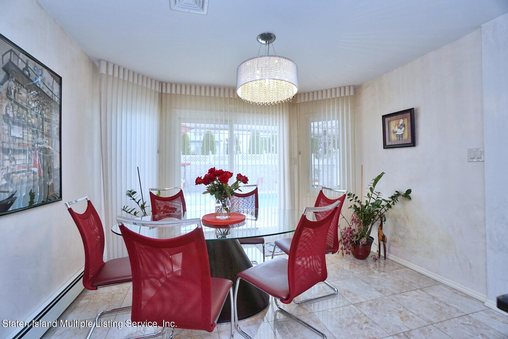 67 Covington Circle Staten Island, NY 10312 - Photo 18 of 45 a view of a dining room with furniture and chandelier