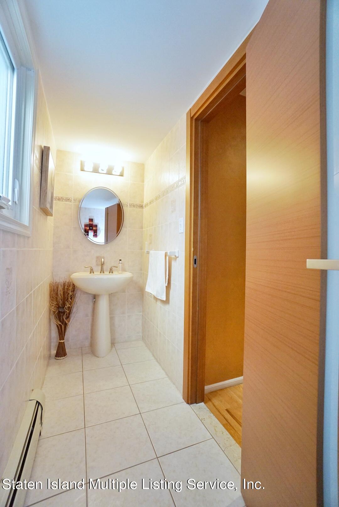 67 Covington Circle Staten Island, NY 10312 - Photo 19 of 45 a bathroom with a sink toilet and shower