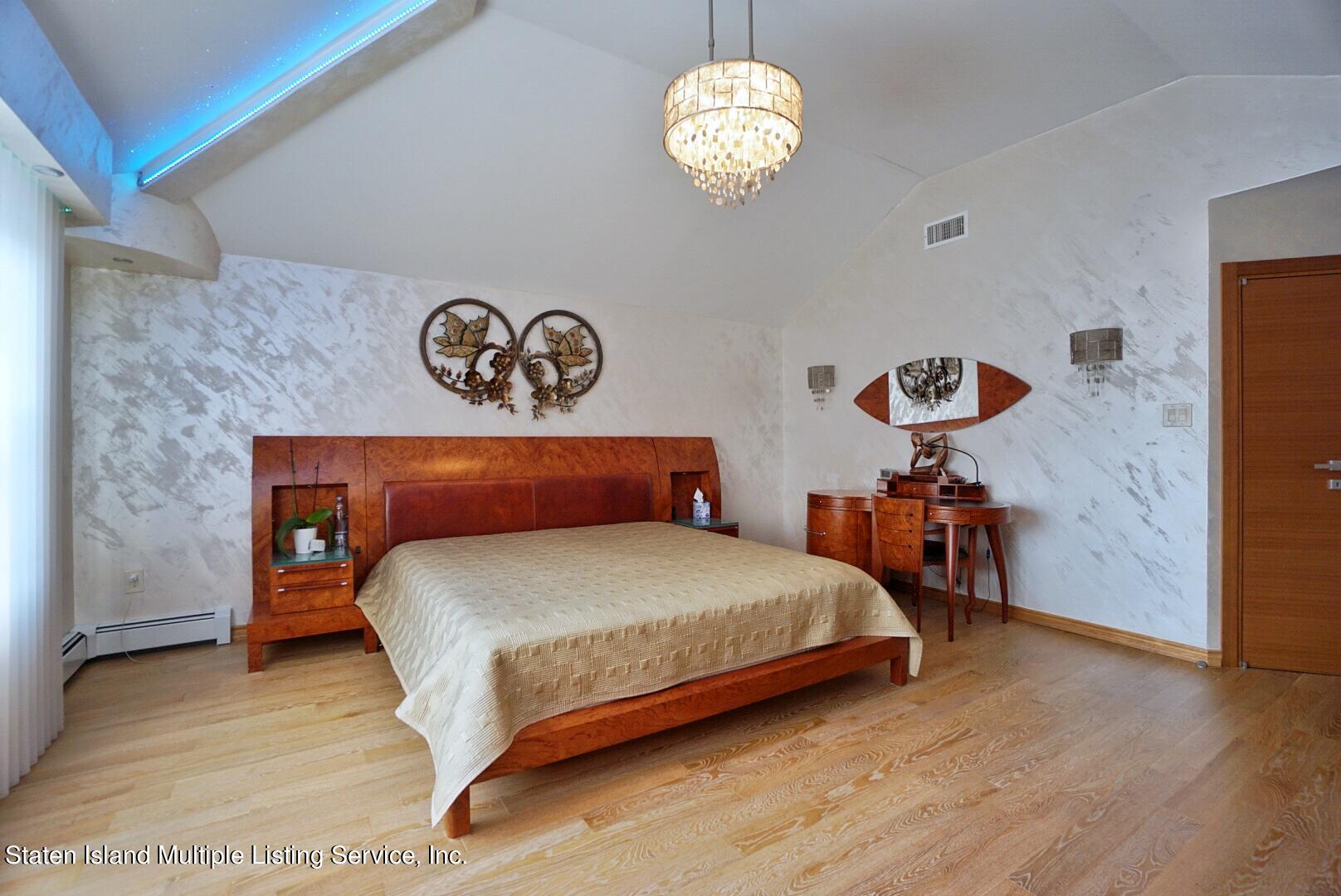67 Covington Circle Staten Island, NY 10312 - Photo 23 of 45 a bedroom with a bed and a table