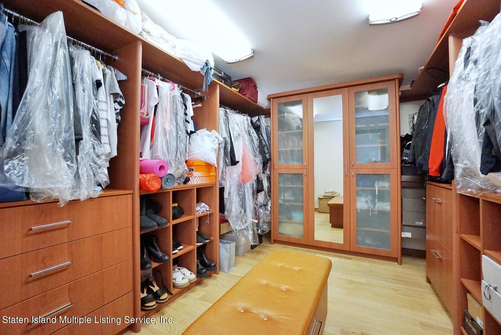 67 Covington Circle Staten Island, NY 10312 - Photo 25 of 45 a view of walk in closet with clothes and shoes