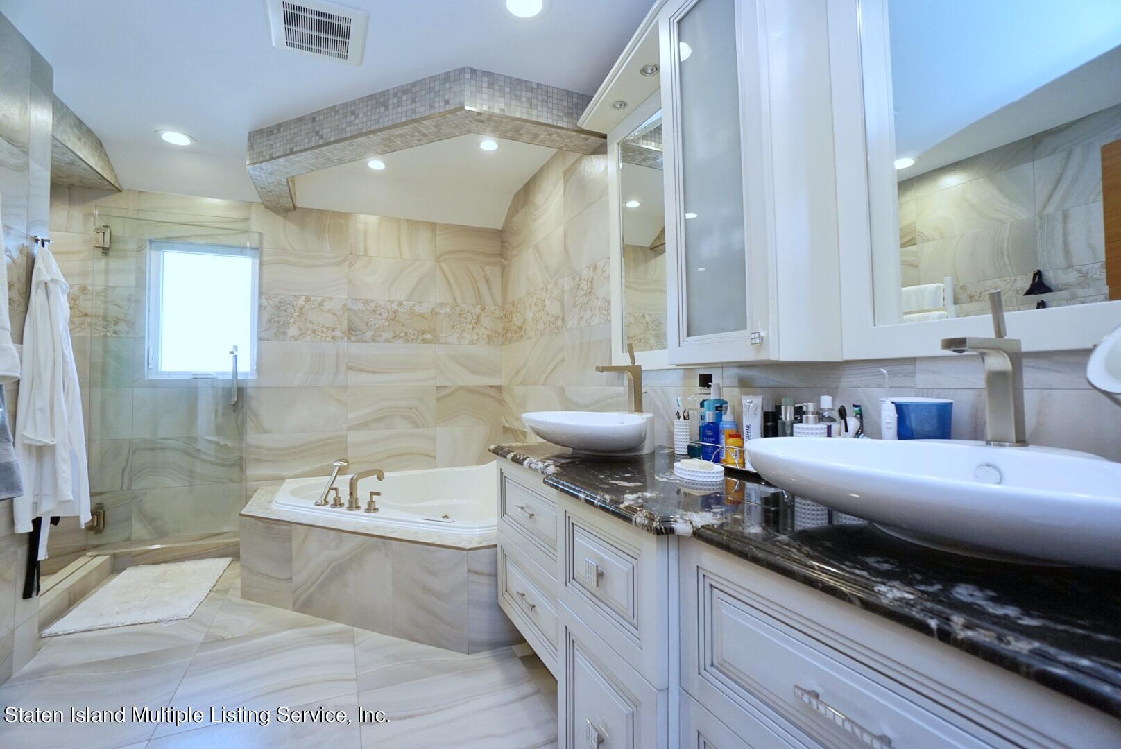 67 Covington Circle Staten Island, NY 10312 - Photo 26 of 45 a large white kitchen with a large window
