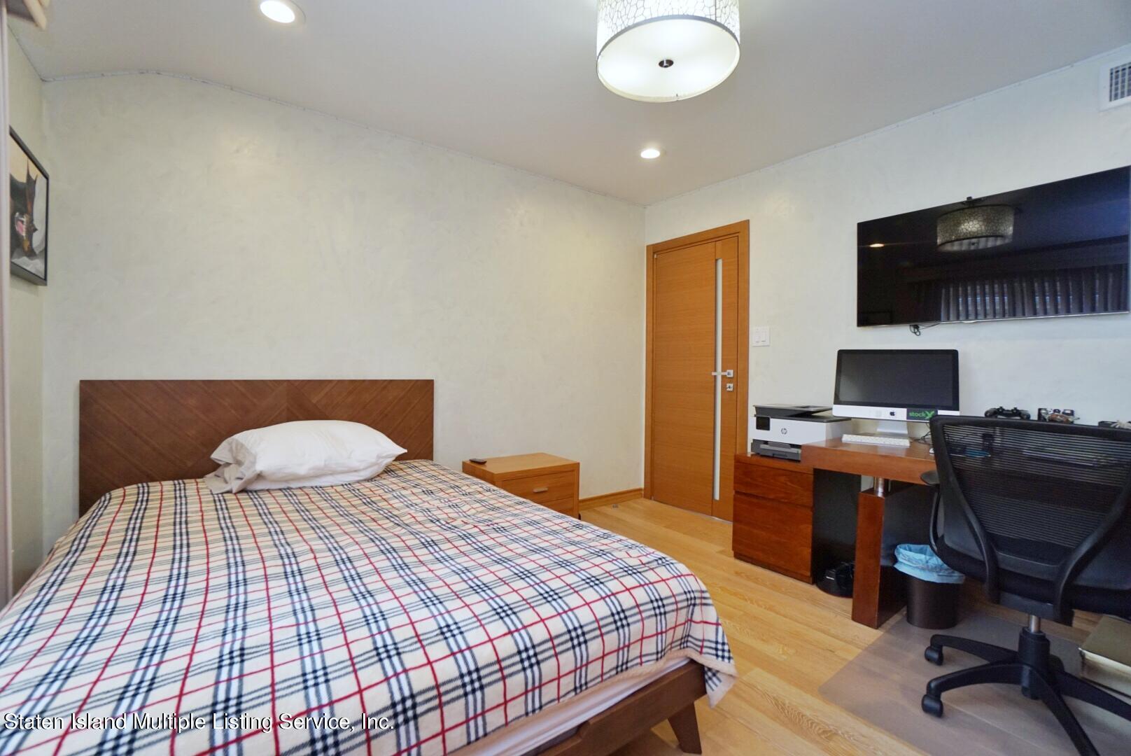 67 Covington Circle Staten Island, NY 10312 - Photo 28 of 45 a bedroom with a bed and a desk