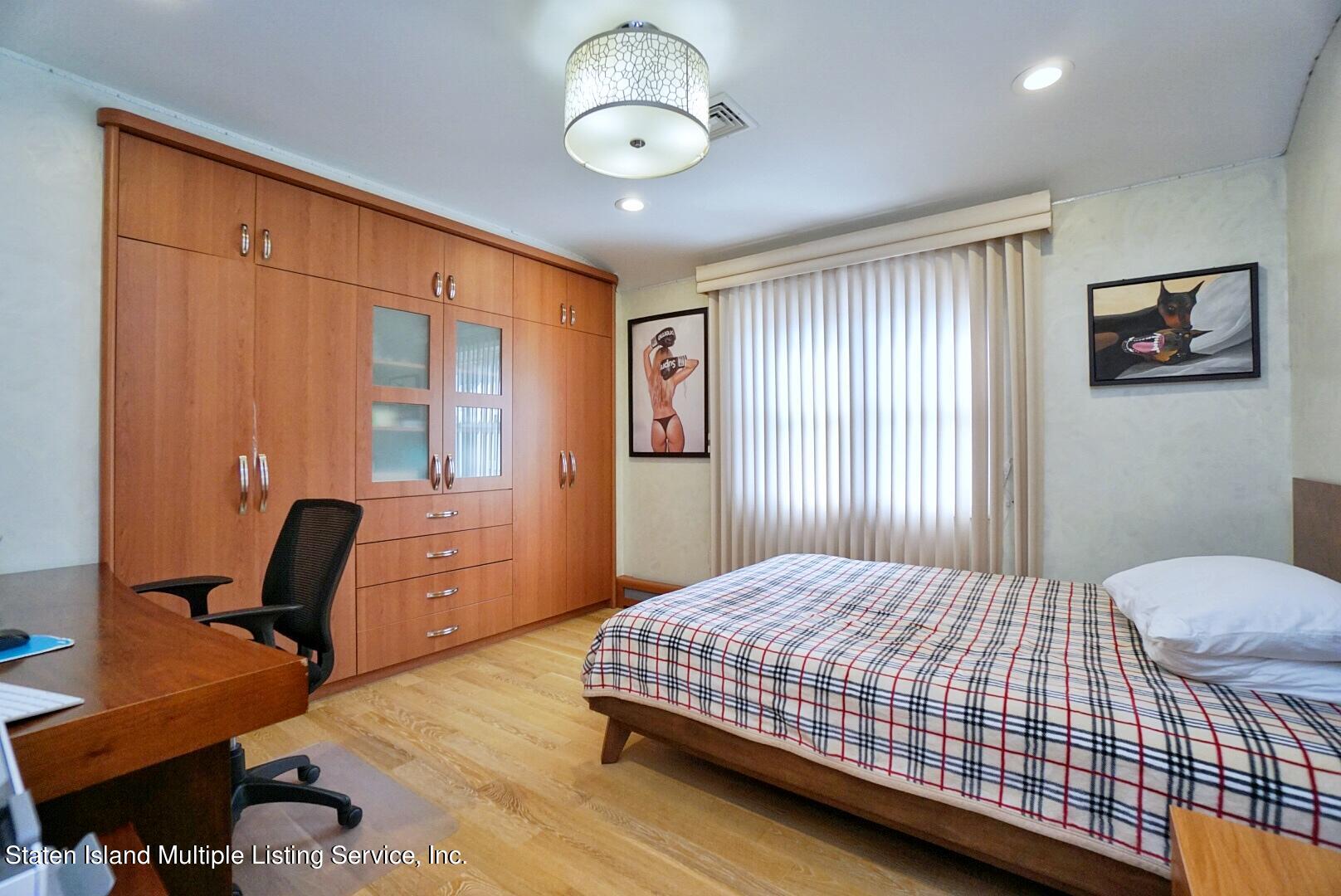 67 Covington Circle Staten Island, NY 10312 - Photo 29 of 45 a bedroom with a bed and a dresser