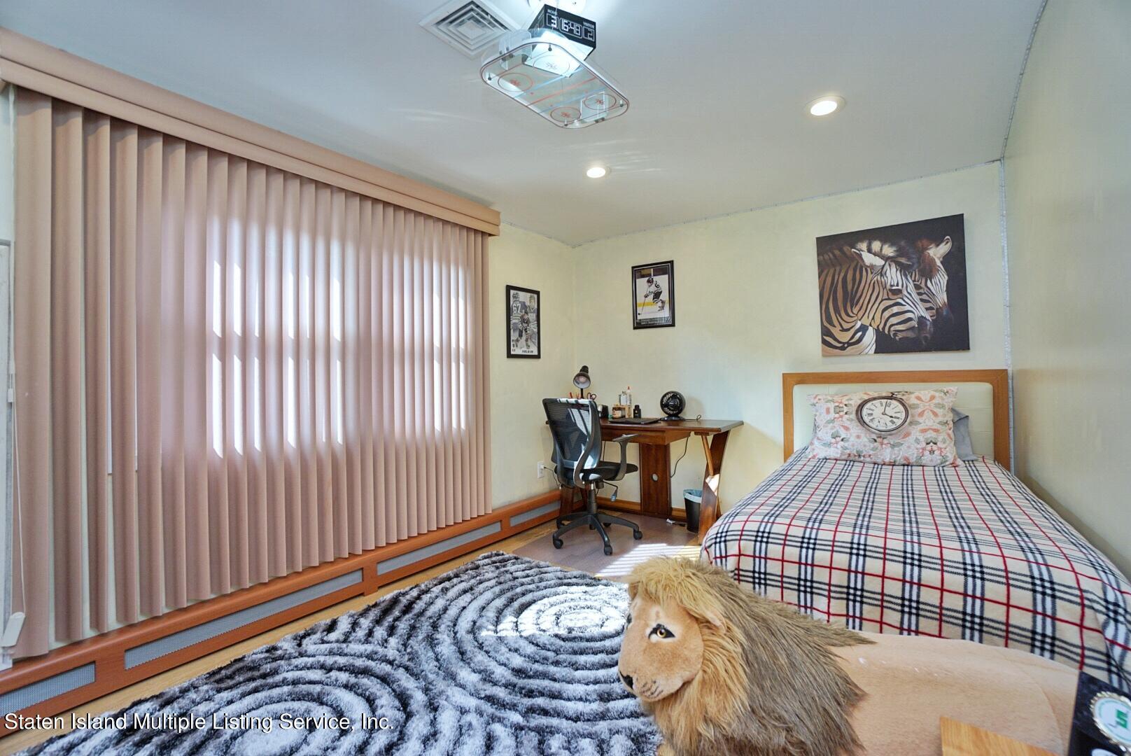 67 Covington Circle Staten Island, NY 10312 - Photo 30 of 45 a bedroom with furniture and a bed