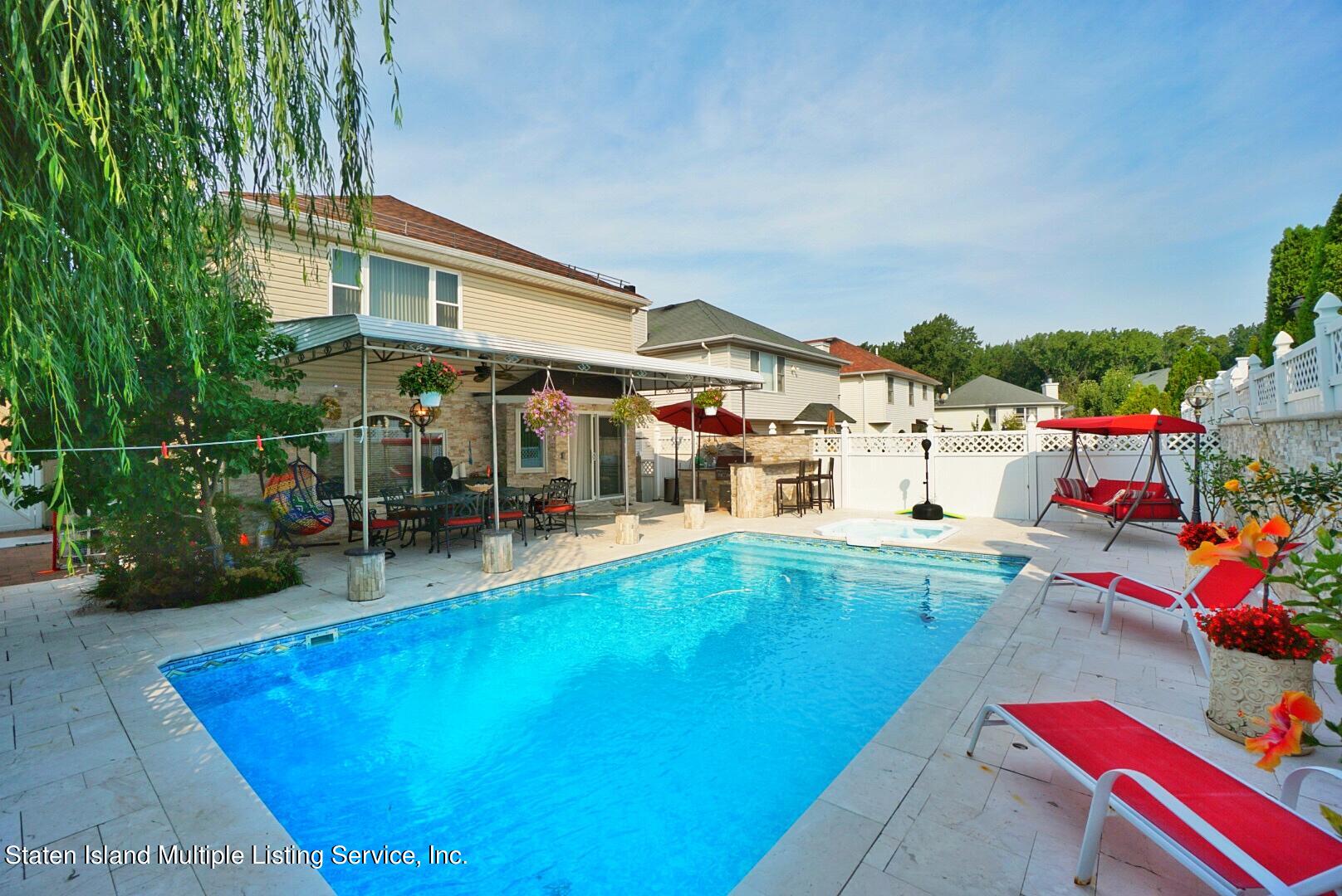 67 Covington Circle Staten Island, NY 10312 - Photo 3 of 45 a view of a swimming pool with a patio