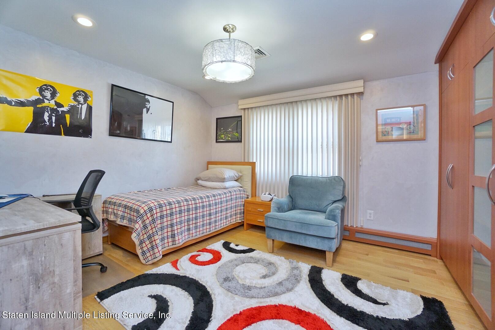 67 Covington Circle Staten Island, NY 10312 - Photo 33 of 45 a bedroom with a bed and lamp
