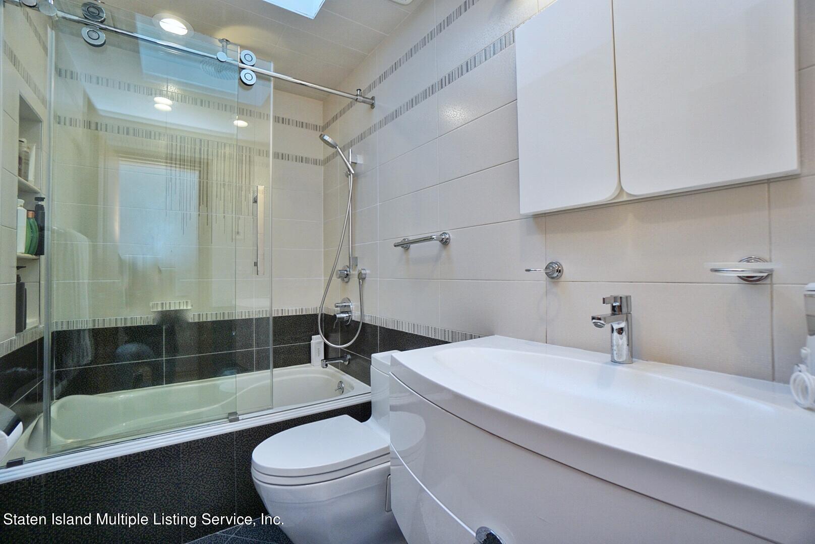 67 Covington Circle Staten Island, NY 10312 - Photo 34 of 45 a bathroom with a sink a toilet and shower