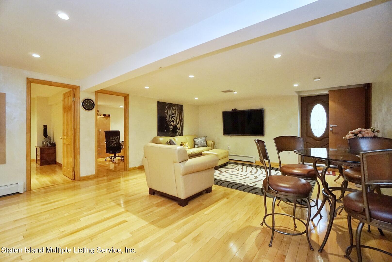 67 Covington Circle Staten Island, NY 10312 - Photo 35 of 45 a living room with furniture and a flat screen tv