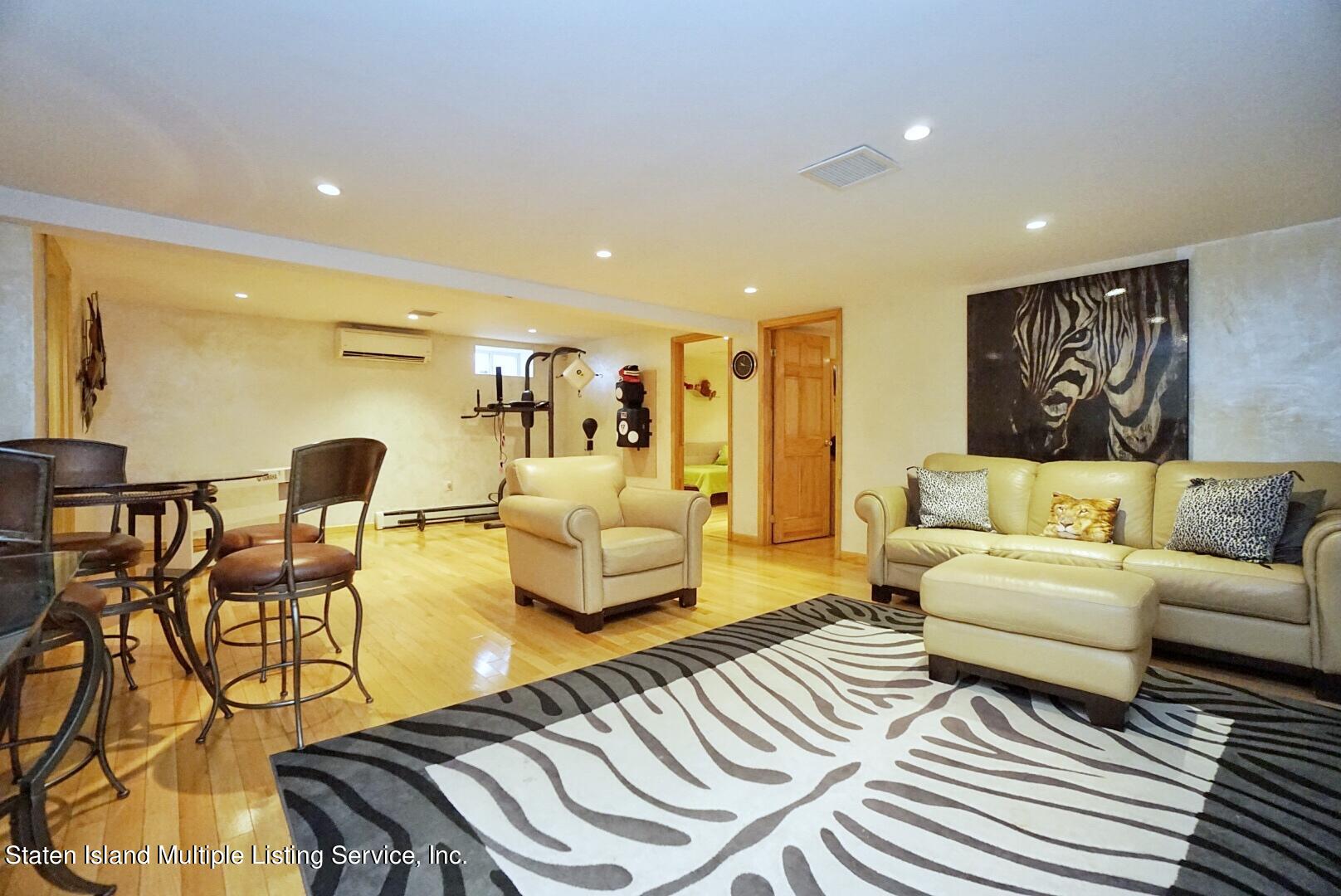 67 Covington Circle Staten Island, NY 10312 - Photo 36 of 45 a living room with furniture and a wooden floor