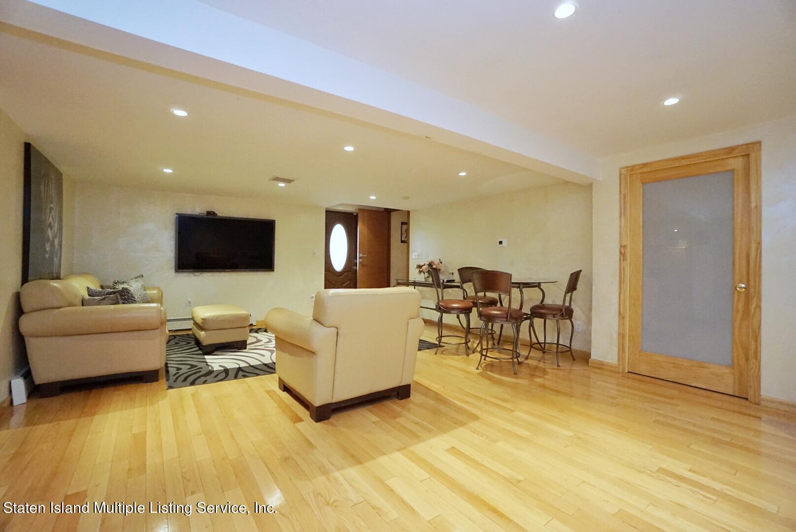 67 Covington Circle Staten Island, NY 10312 - Photo 37 of 45 a living room with furniture and a flat screen tv
