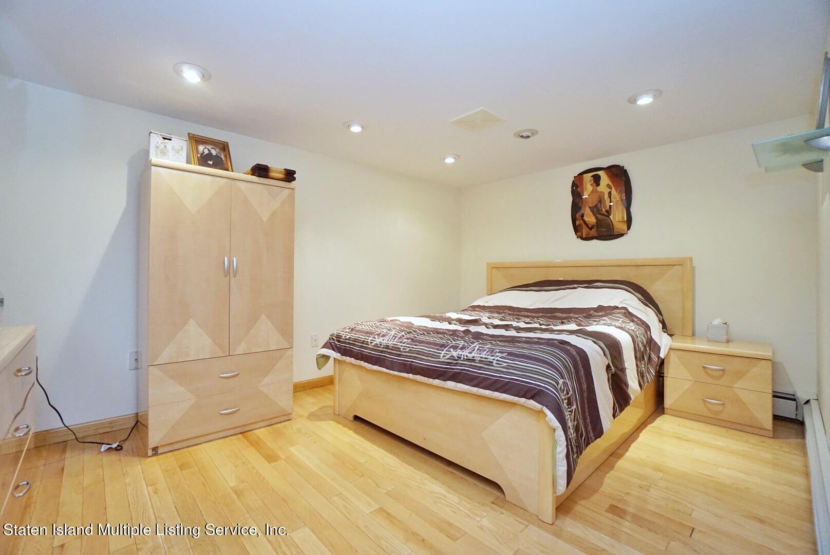 67 Covington Circle Staten Island, NY 10312 - Photo 41 of 45 a bedroom with a bed and a walk in closet