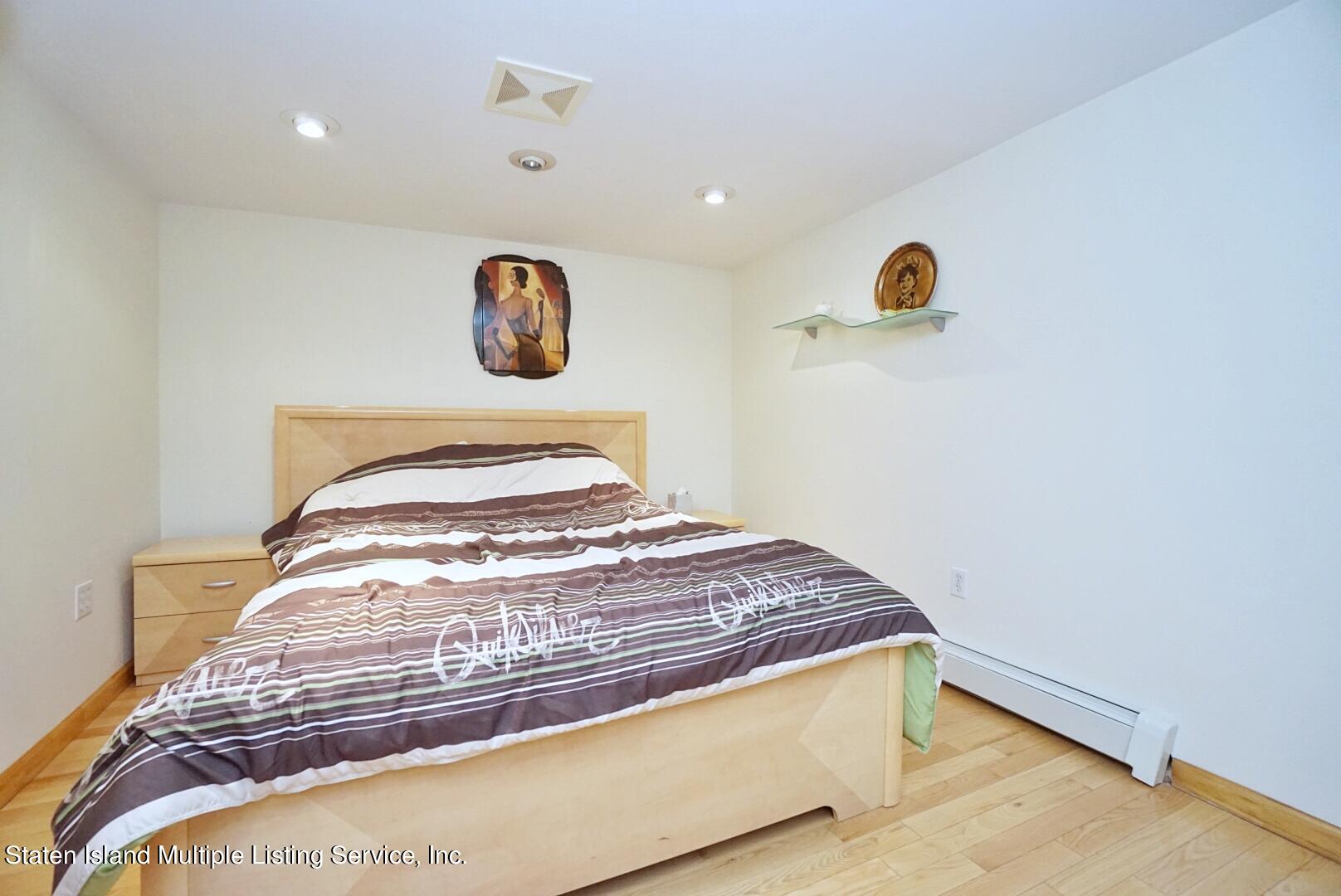 67 Covington Circle Staten Island, NY 10312 - Photo 42 of 45 a bedroom with a bed and window
