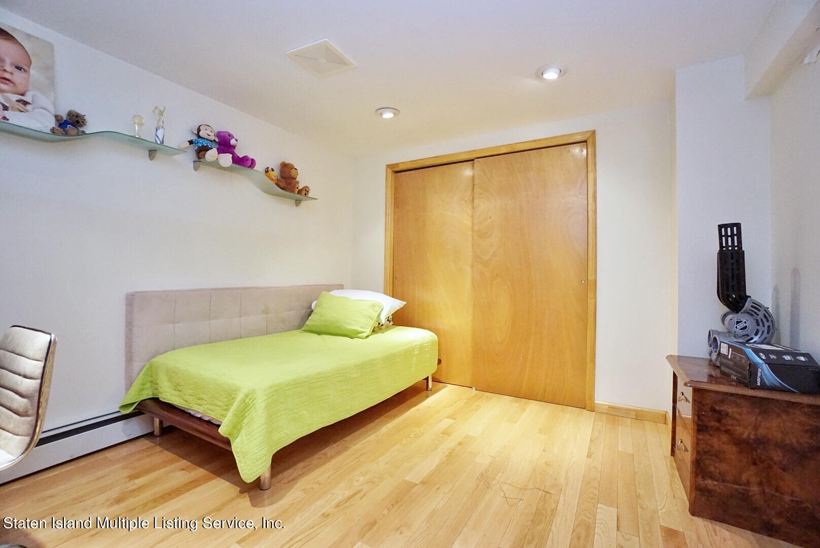 67 Covington Circle Staten Island, NY 10312 - Photo 43 of 45 a bedroom with a bed and a flat screen tv